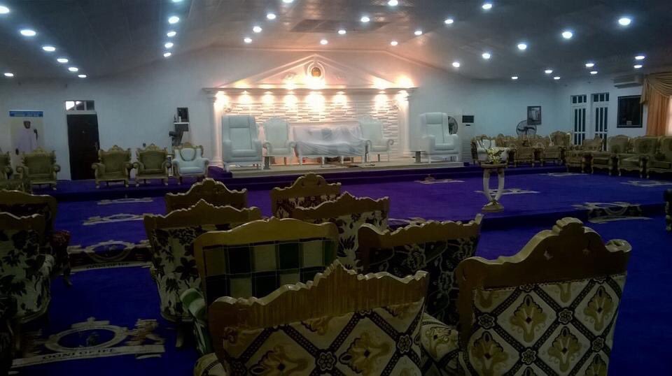 The empty Royal Hall at Ile Oodua palace, showing gold ceremonial chairs, a purple carpet, and the elevated dais where the Ooni sits.
